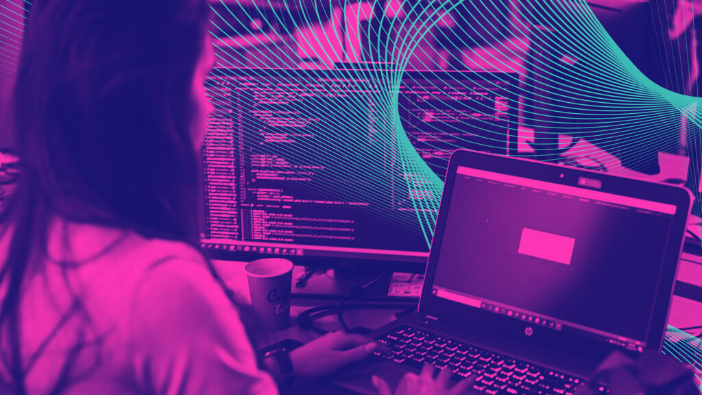 a woman uses a computer at her desk