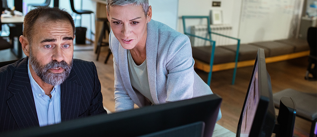 Two colleagues work together on AI powered data analysis for faster insights