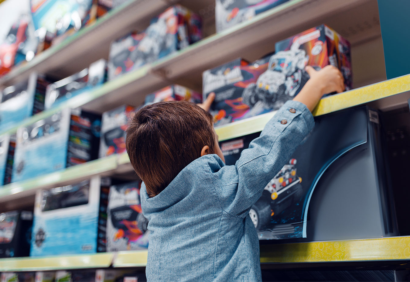 toy-retailer-client-story-mid Child picking out toy car in retail store
