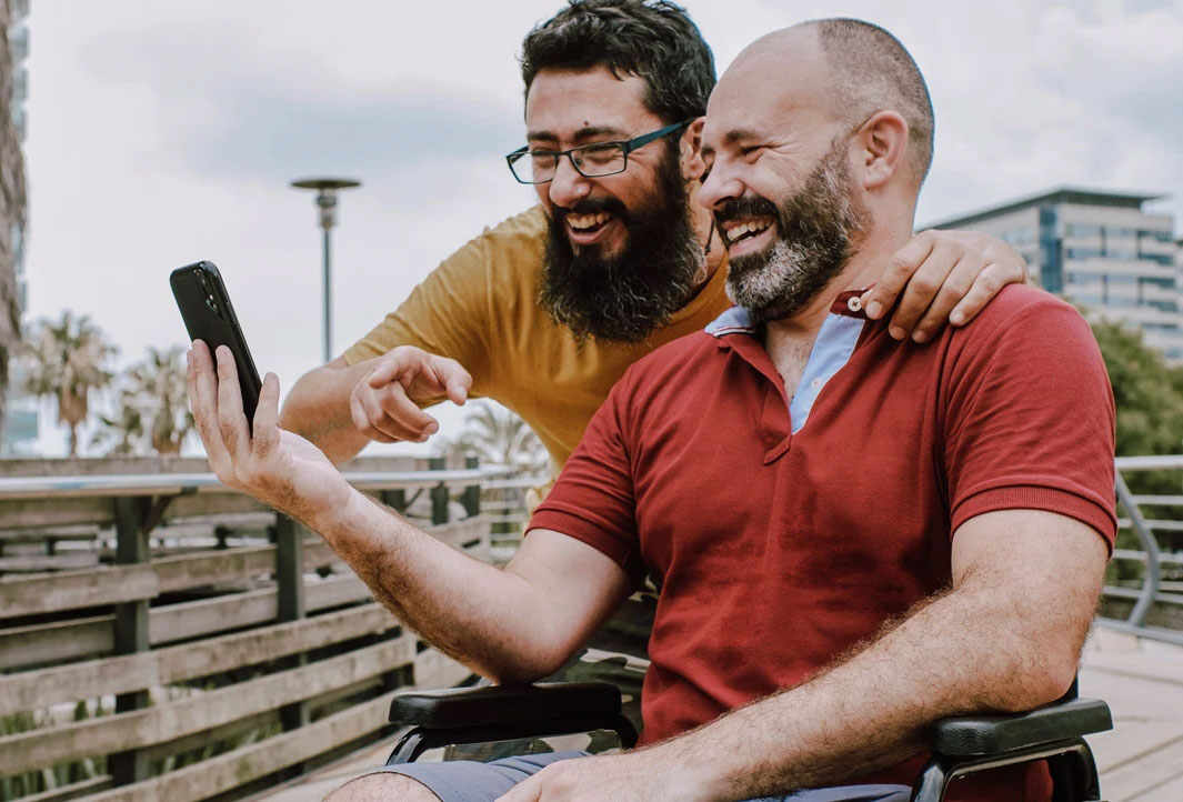 Two men delighted by a mobile healthcare app feature