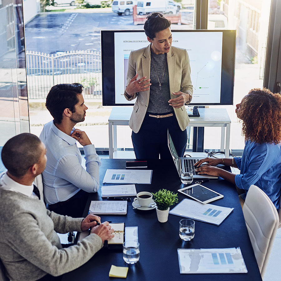 employees in a meeting discussing insights unlocked by adobe analytics