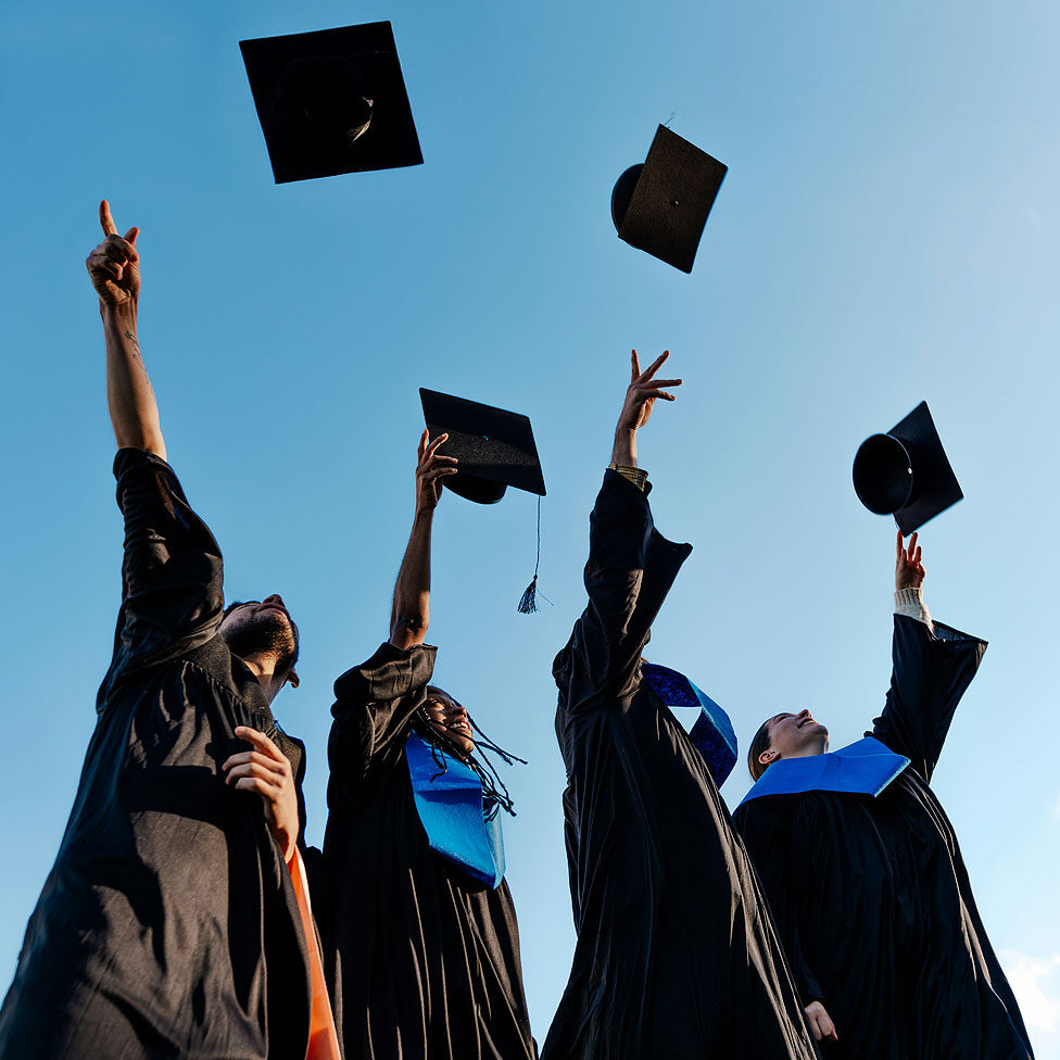 Graduates tossing caps in the air
